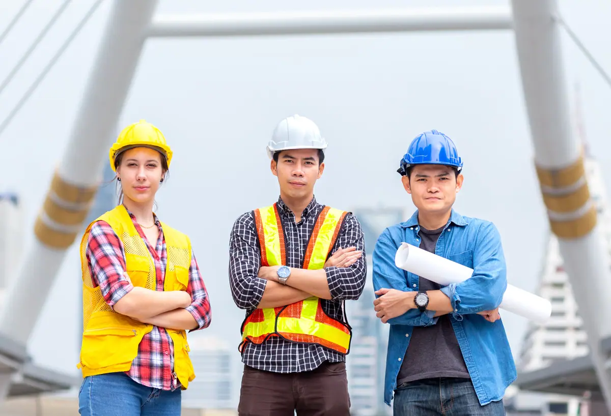 Three engineers facing forward at a project site